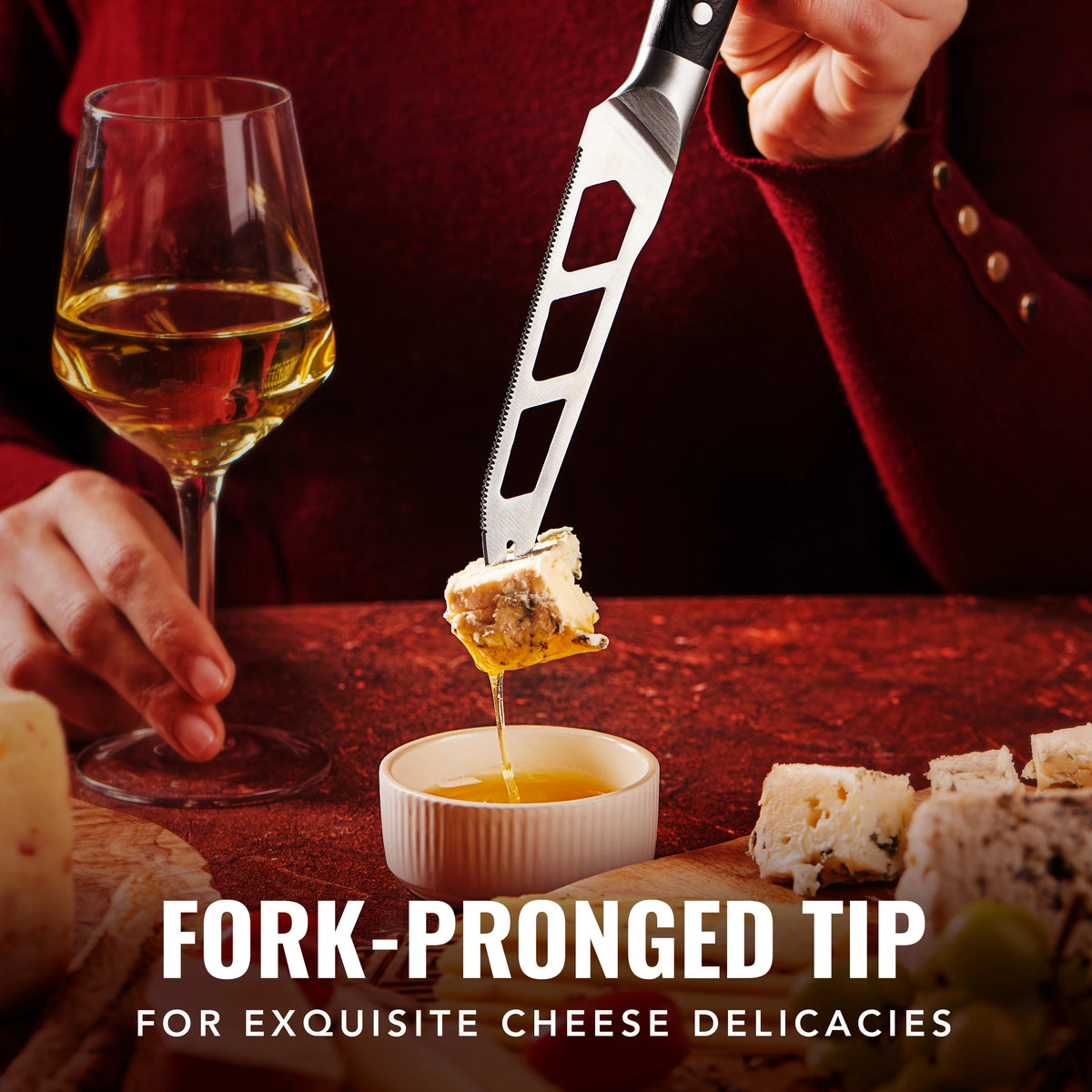 Product image 5 of 9: Fork-pronged tip knife lifting cheese with honey, paired with wine for gourmet dining