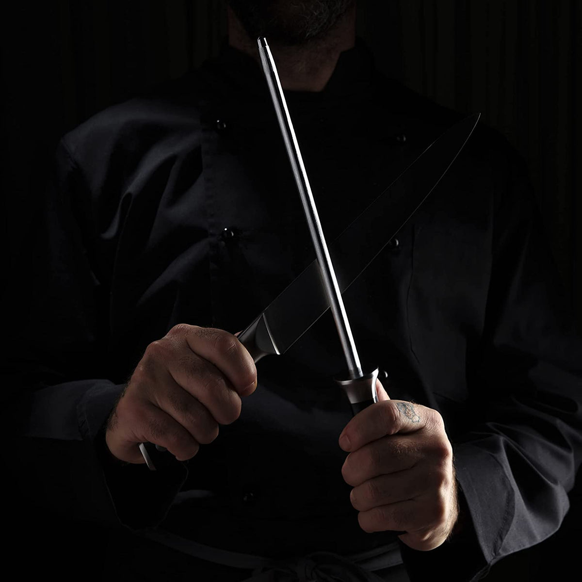 Product image 5 of 8: Chef sharpening kitchen knife with steel, professional chef in black coat, precision blade care