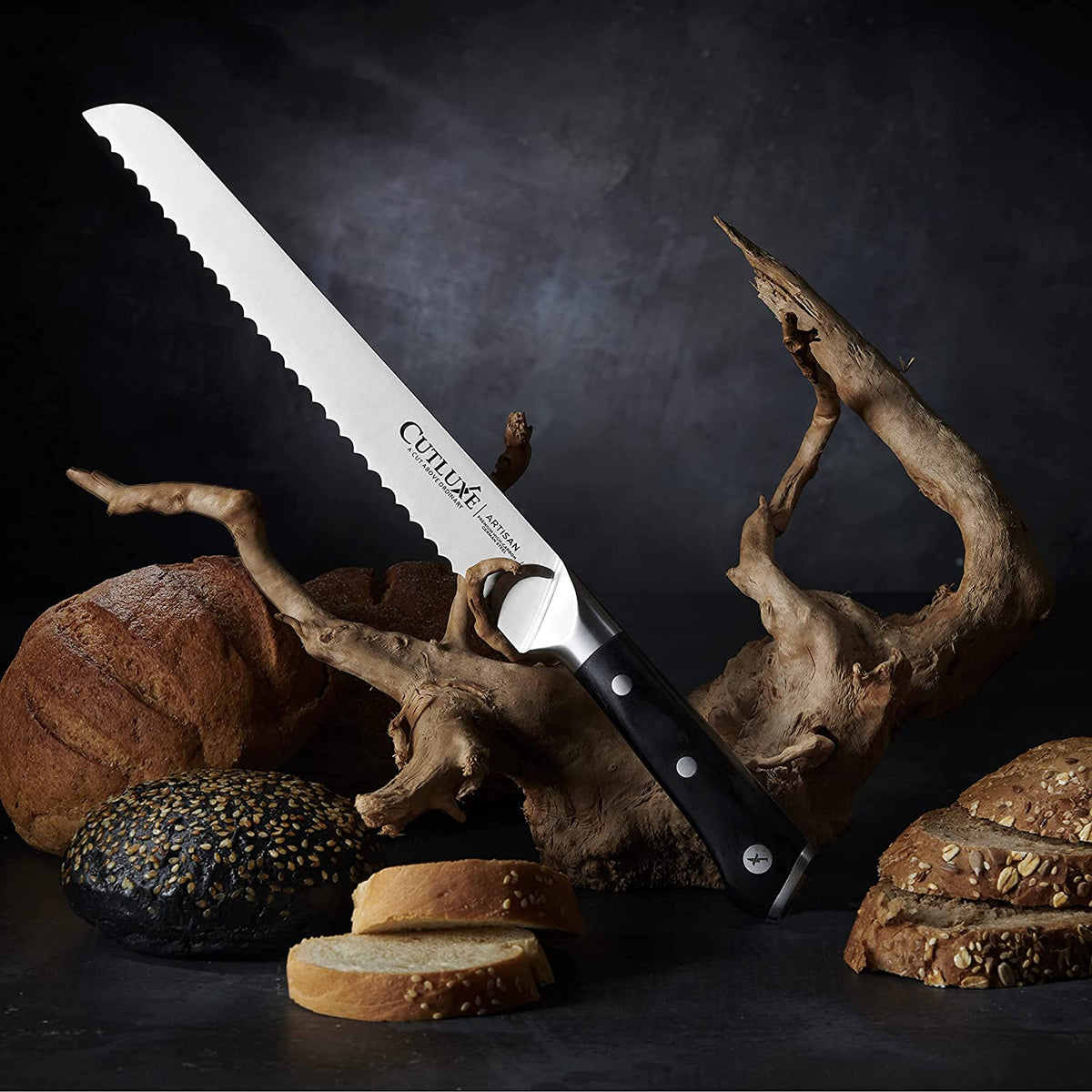 Product image 3 of 9: Serrated bread knife with black handle, slicing fresh bread on rustic wooden display