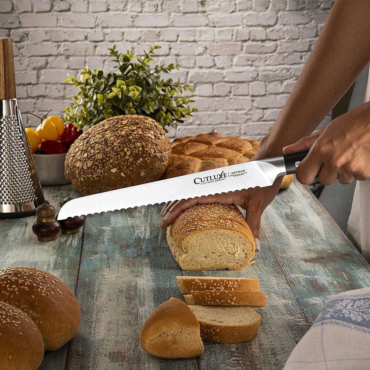 Product image 2 of 9: Slicing fresh bread with a serrated kitchen knife on a rustic table