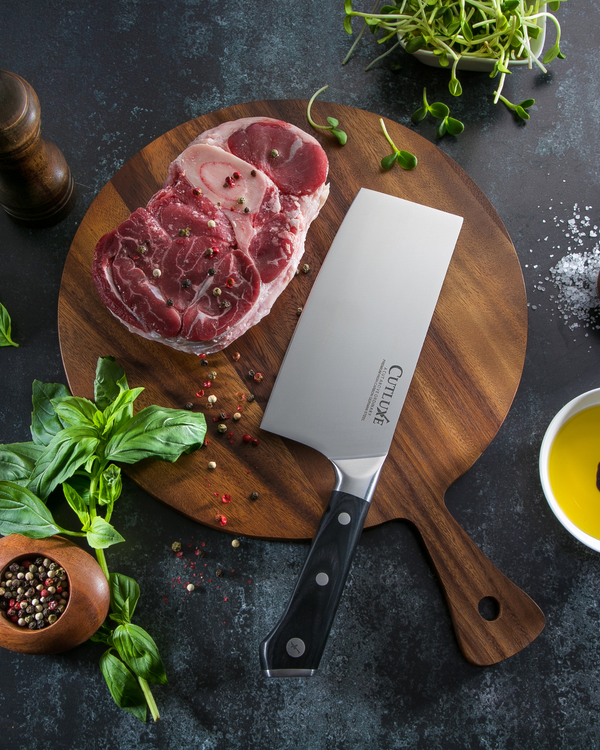 Premium kitchen cleaver with raw meat on wooden cutting board, surrounded by herbs and spices