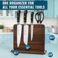 Wooden cutting board with knives and scissors on a kitchen counter