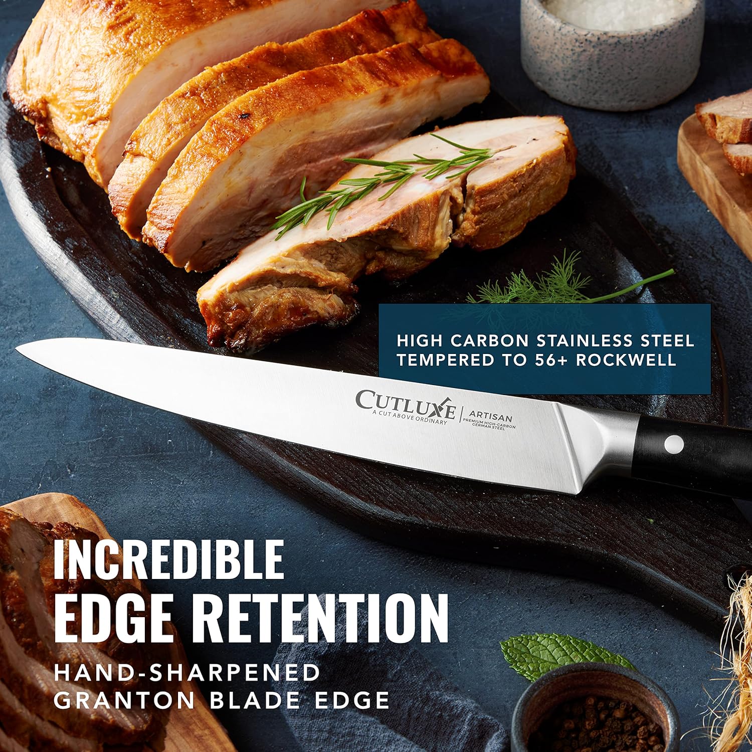 Product image 4 of 7: Cutluxe artisan carving knife with high carbon steel blade, slicing roasted pork on dark platter
